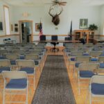 Empty meeting room with rows of chairs.