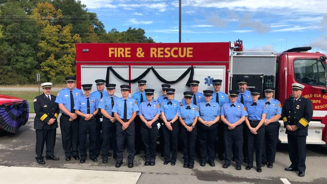 Firefighters in front of Fire & Rescue truck
