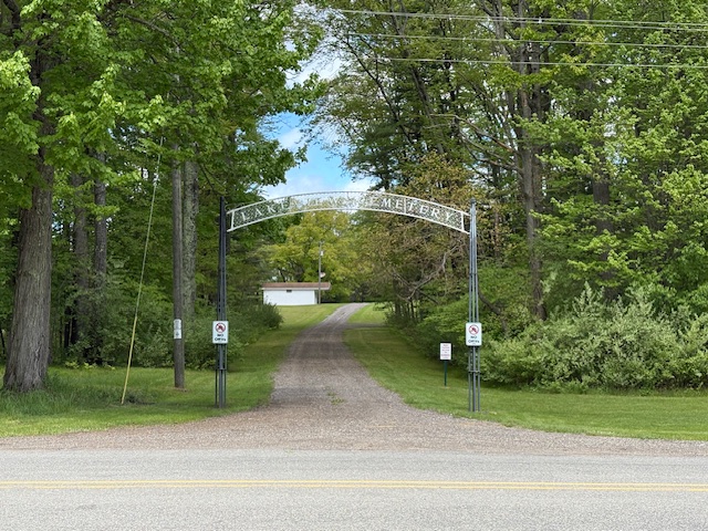 Entrance to Lakeview Cemetery surrounded by trees.