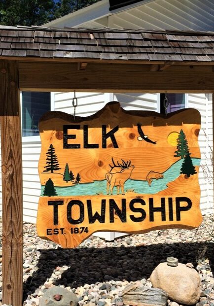 elktwpsignmcintire Elk Township sign with trees and deer illustration.